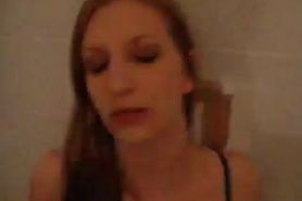 Redhead gives a blowjob in a bathroom