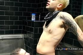Trailer:Two Guys in Rubber Have some fun in the Restroom after Pissing