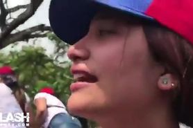 Venezuelan protester flashes to reporters