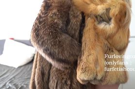 Fur fetish couple kissing in raccoon and red fox fur coat