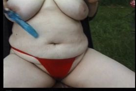 Voluptuous brunette fucks her horny pussy outdoors