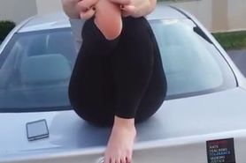 Beauty sitting on the car in her yoga pants showcasing her delicious amateur feet