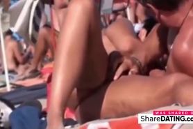 a couple masturbates on nudist beach
