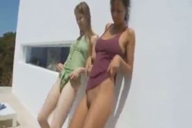 Two girlfriends peeing on a terrace