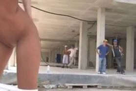 Brunette whore fucked in public near a horde of workers