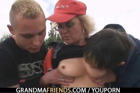 Blond granny has threesome outdoors