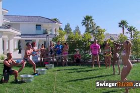 Swingers get naked wet and slippery in a funny sex game in the yard before having intense pleasure