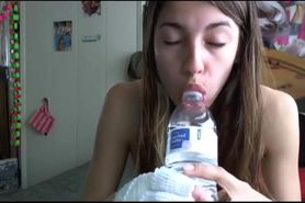 Cute teen girl passionately sucks water bottle