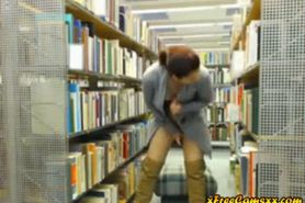 Hot redhead milf flashes and rubs pussy in library