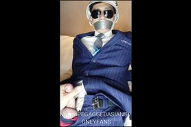 Korean model slave in navy stripe suit, bound and tape gagged, cum control