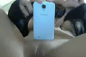 Brunette teen shows her smartphone and pussy