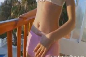 Thin girl teasing and fingering pussy on a balcony