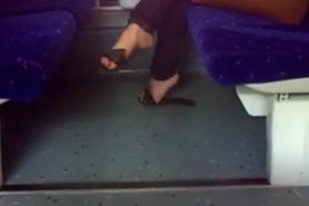 Candid flip flops dangling in train