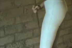 Girl Wets her Jodhpurs with a Hose in the Stables