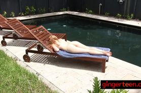 Muscular dude seduces redhead as she is sunbathing by the pool