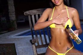 Denise Gomez posing in her yellow bikini