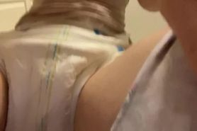 Diaper girl wets another diaper