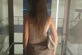 Woman in skirt shows ass and tits in transparent elevator