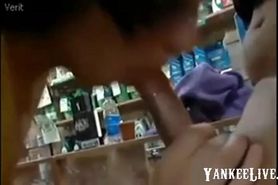 Two girls giving blowjob in shop