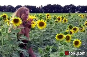 Alena posing between sunflowers
