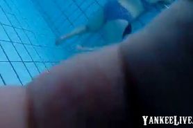 girsl underwater at pool