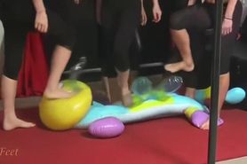 Girls trampling large inflatable toy