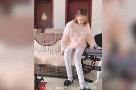 Asian paraplegic woman transfering, playing with dead legs