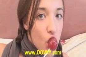 Brunette chick sucking lollypop