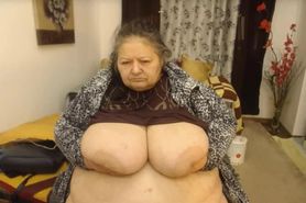 granny holds saggy white boobs up