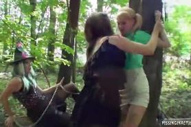 Lesbian Vixen pissing in a huge lesbian group outdoors in the forest.
