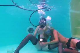 Scuba girls sucking on regulator and playing underwater