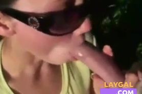 She sucks dick outdoors and eats cum out of a condom