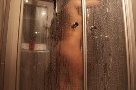 Muscular Fit Girl taking a shower