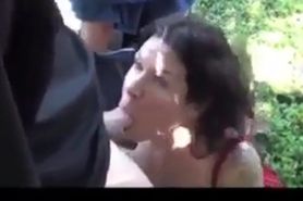 Tattooed slut jerking off several guys in the woods