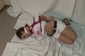 Sexy hogtied girl in shorts . . .